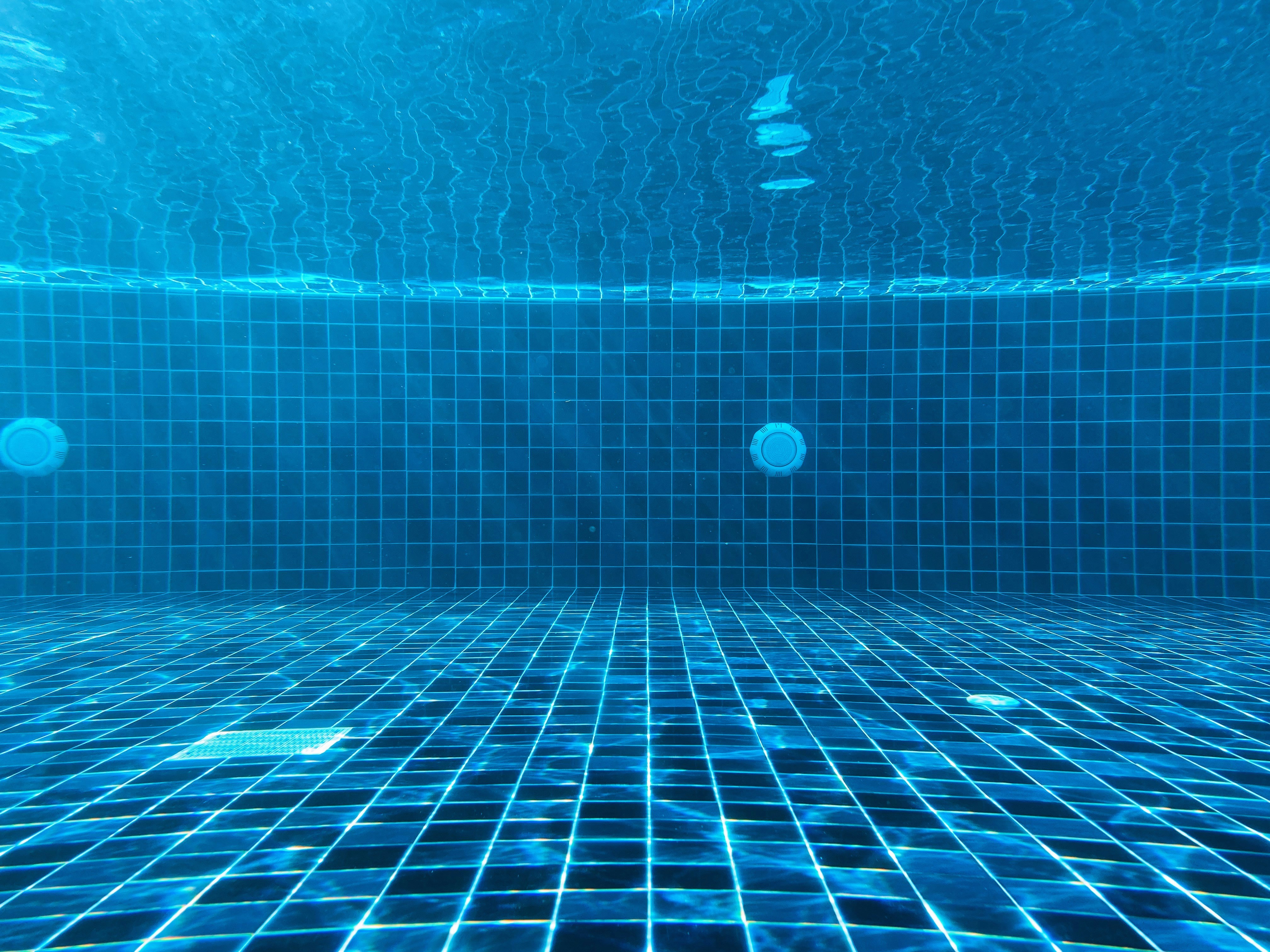 Pool inspection in Hawaii — underwater view of clean pool tile and structure