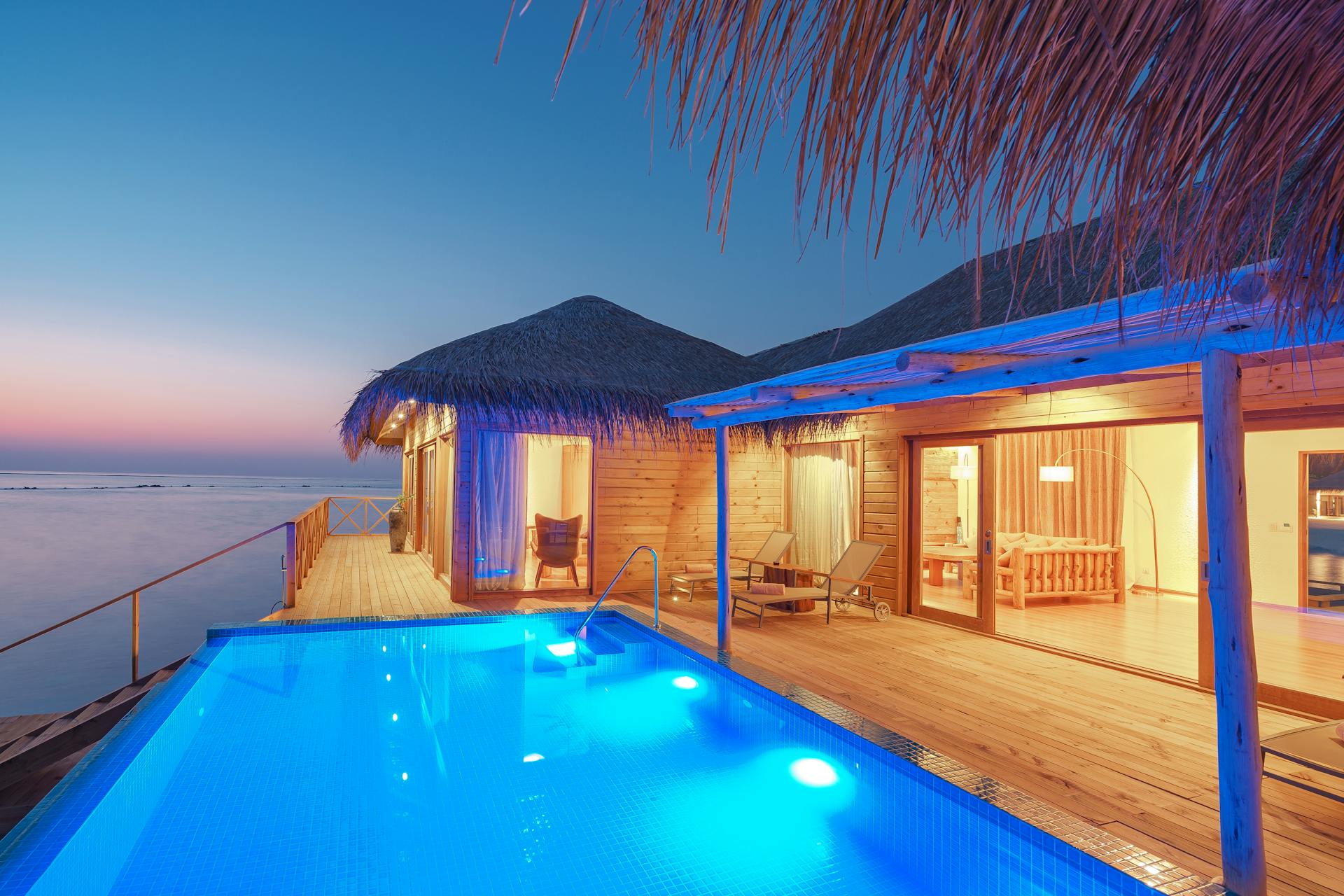 Inviting tropical pool with loungers and palm trees year-round